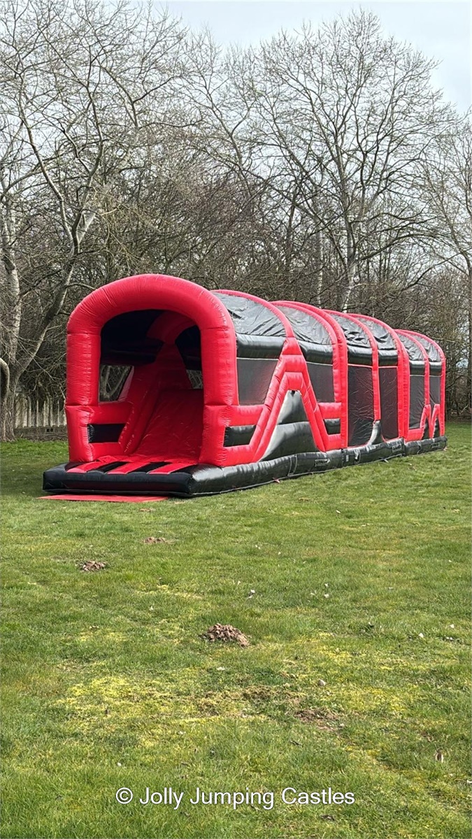 Red & Black Assault Course 70ft - Hire in Stockport | Jolly Jumping Castles
